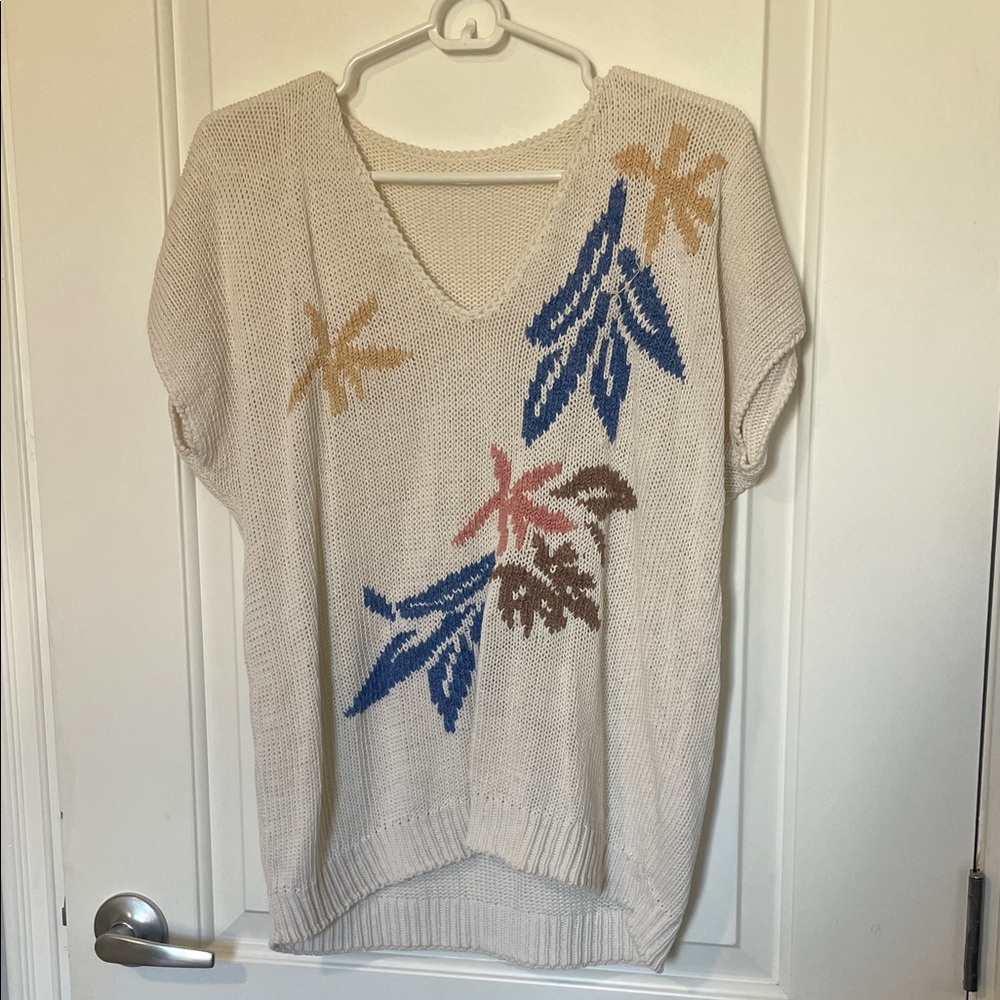 Cream V-Neck Sweater with Blue and Brown Leaf Design